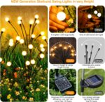 A cluster of ASMAD 6-pack solar firefly garden lights swaying gently in a landscaped garden at dusk.