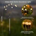 A cluster of ASMAD 6-pack solar firefly garden lights swaying gently in a landscaped garden at dusk.