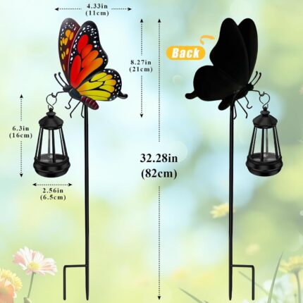 A white metal butterfly garden stake with a colorful monarch butterfly and a warm glowing solar light on its antennae, placed