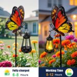 A white metal butterfly garden stake with a colorful monarch butterfly and a warm glowing solar light on its antennae, placed