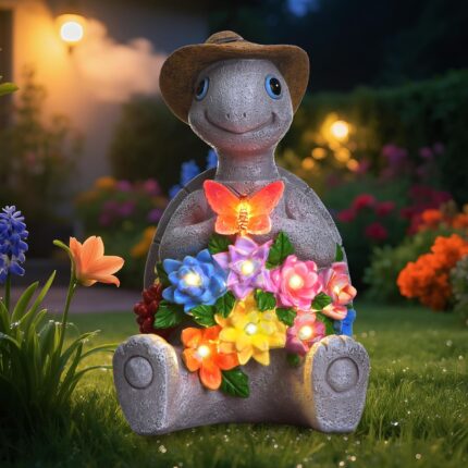 A colorful solar-powered turtle statue wearing a cowboy hat and holding a butterfly, glowing with 8 LED lights in a garden se