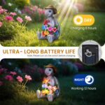 A colorful solar-powered turtle statue wearing a cowboy hat and holding a butterfly, glowing with 8 LED lights in a garden se