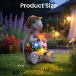 A colorful solar-powered turtle statue wearing a cowboy hat and holding a butterfly, glowing with 8 LED lights in a garden se