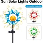 Kacux blue metal sun solar garden stake light with crackle glass globe, emitting a warm glow in an outdoor setting.