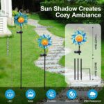 Kacux blue metal sun solar garden stake light with crackle glass globe, emitting a warm glow in an outdoor setting.