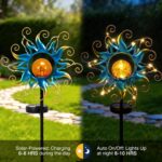 Kacux blue metal sun solar garden stake light with crackle glass globe, emitting a warm glow in an outdoor setting.