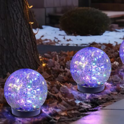 Six MLKNK solar globe lights with cracked glass texture, emitting a multicolor glow, placed in a garden setting.