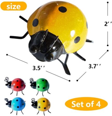 Four colorful metal ladybug sculptures displayed on a garden wall and a green lawn, showcasing their vibrant hues.