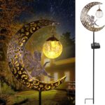 A bronze moon fairy solar garden light with a crackle glass globe, illuminating a pathway at dusk.