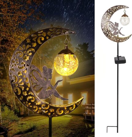 A bronze moon fairy solar garden light with a crackle glass globe, illuminating a pathway at dusk.