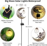 A bronze moon fairy solar garden light with a crackle glass globe, illuminating a pathway at dusk.