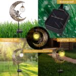 A bronze moon fairy solar garden light with a crackle glass globe, illuminating a pathway at dusk.