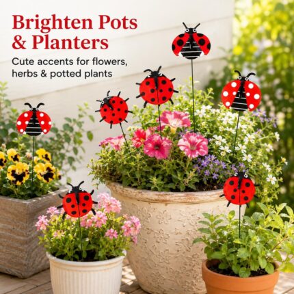 A cluster of 30 red and black 3D ladybug garden stakes, 25cm tall, inserted into green foliage and a potted plant.