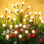 Four black solar lights with large, glowing LED bulbs swaying gently in a garden at dusk, resembling fireflies.